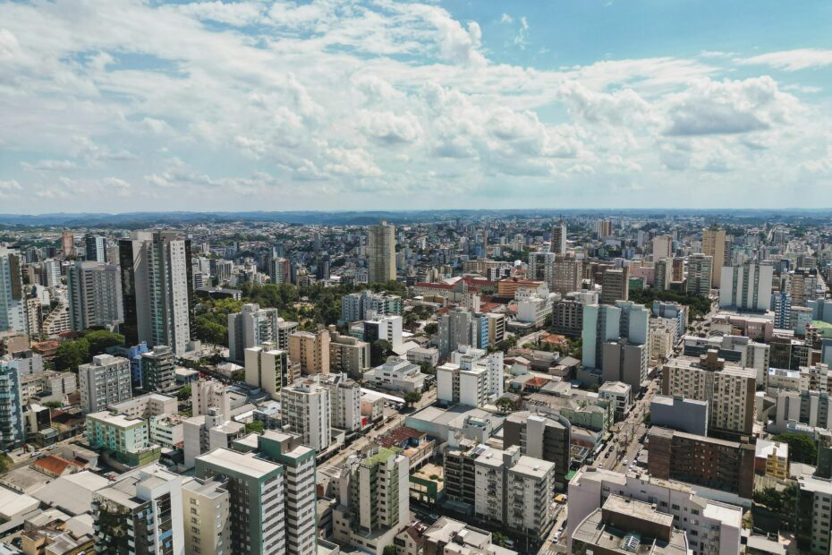 Stunning aerial view of Caxias do Sul showcasing modern buildings and sprawling urban landscape under a clear sky.