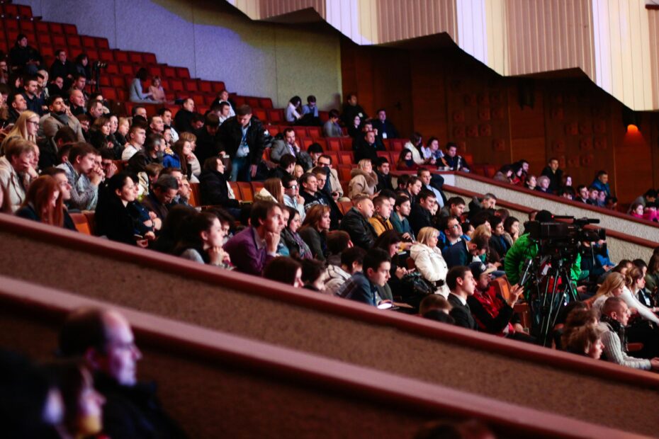 Engaged audience seated indoors, captured with a Canon camera. Ideal for event coverage visuals.